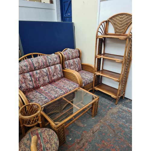 58A - A bamboo and wicker thirteen piece conservatory suite comprising two sofas, two armchairs, four tier... 