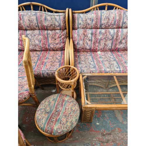 58A - A bamboo and wicker thirteen piece conservatory suite comprising two sofas, two armchairs, four tier... 