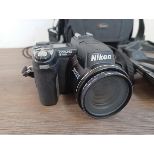 648 - A cased Nikon Coolpix 5700 5.0mp digital camera with strap, cable, cased 256mb flash card and fitted... 