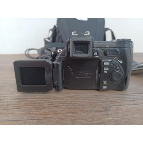 648 - A cased Nikon Coolpix 5700 5.0mp digital camera with strap, cable, cased 256mb flash card and fitted... 