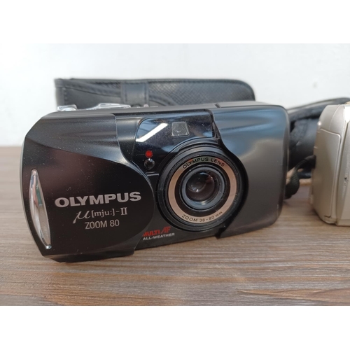 653 - Three cased Olympus mju compact cameras, one µ[mju:]-II Zoom 80 35mm, one µ[mju:]-II 35mm and one µ ... 