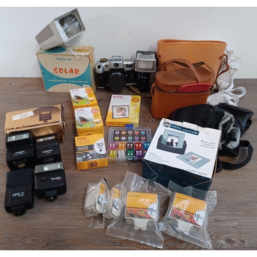 656 - A collection of items to include boxed vintage Photax Solar slide viewer, ink cartridges, Nokina cam... 