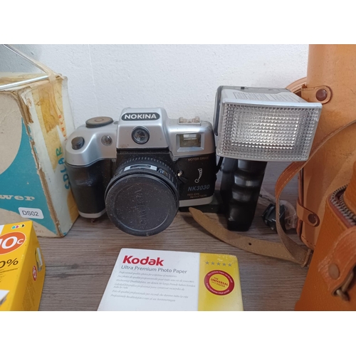 656 - A collection of items to include boxed vintage Photax Solar slide viewer, ink cartridges, Nokina cam... 