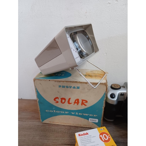 656 - A collection of items to include boxed vintage Photax Solar slide viewer, ink cartridges, Nokina cam... 