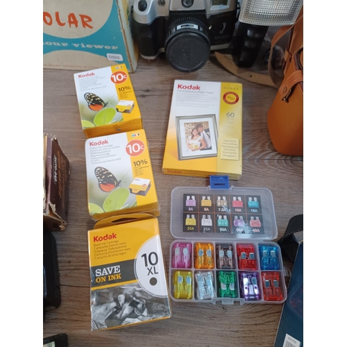 656 - A collection of items to include boxed vintage Photax Solar slide viewer, ink cartridges, Nokina cam... 