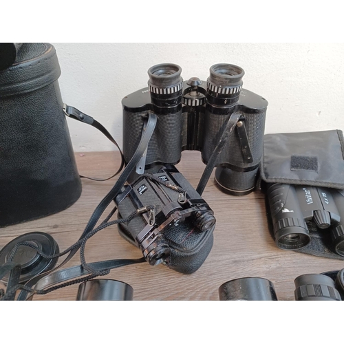 657 - A large collection of binoculars to include cased Boots Admiral 10 x 50, cased Rand Royal-View No.2 ... 