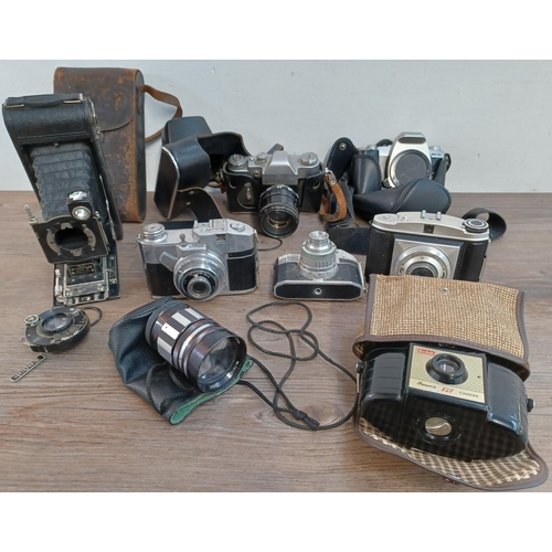 660 - A collection of cameras and lenses to include cased KMZ Zenit 3M 35mm SLR fitted with Helios-44 2/58... 