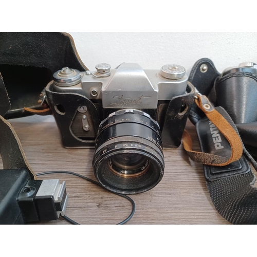 660 - A collection of cameras and lenses to include cased KMZ Zenit 3M 35mm SLR fitted with Helios-44 2/58... 