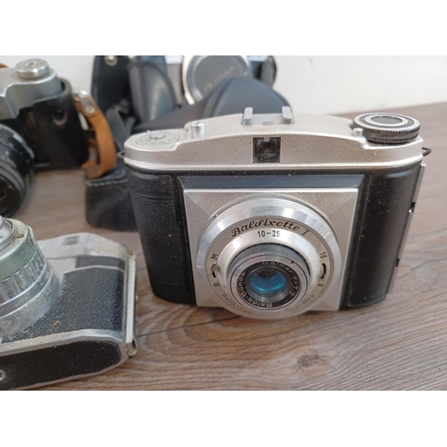 660 - A collection of cameras and lenses to include cased KMZ Zenit 3M 35mm SLR fitted with Helios-44 2/58... 