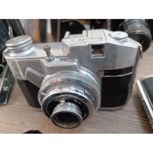 660 - A collection of cameras and lenses to include cased KMZ Zenit 3M 35mm SLR fitted with Helios-44 2/58... 