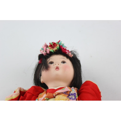 353 - Four Oriental collector's dolls