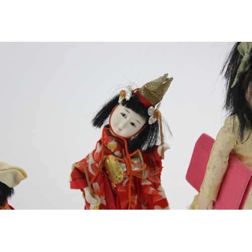 353 - Four Oriental collector's dolls