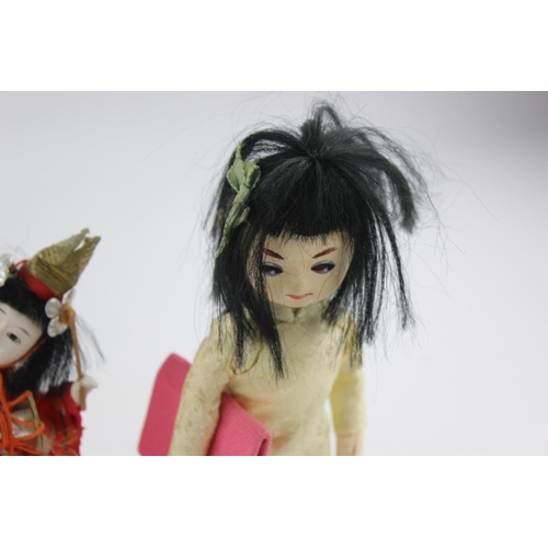 353 - Four Oriental collector's dolls