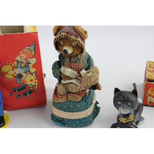 358 - Three vintage tinplate toys to include Hungry Baby Bear, Tri-ang Minic Kitty and Butterfly etc.