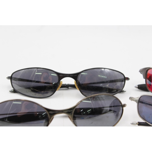 384 - Four pairs of Oakley sunglasses