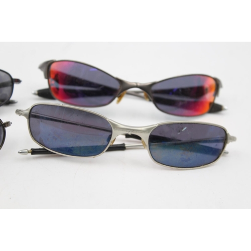 384 - Four pairs of Oakley sunglasses