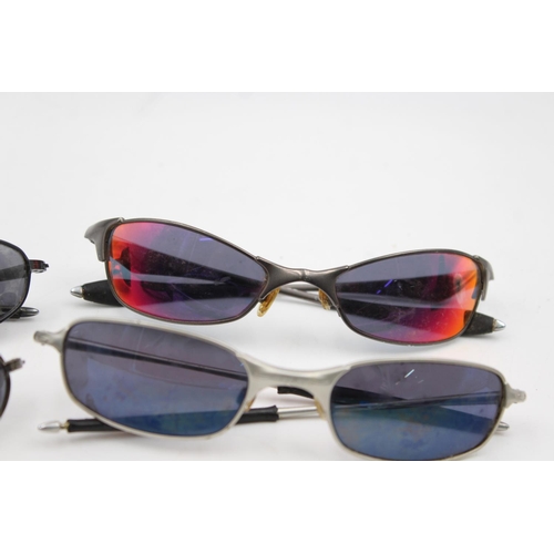 384 - Four pairs of Oakley sunglasses