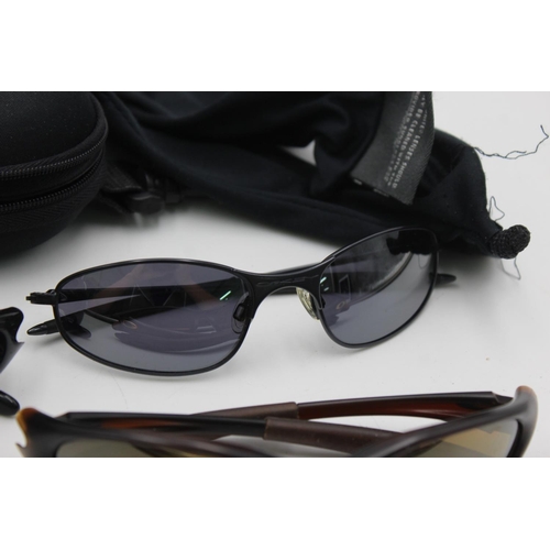 387 - Three pairs of Oakley sunglasses