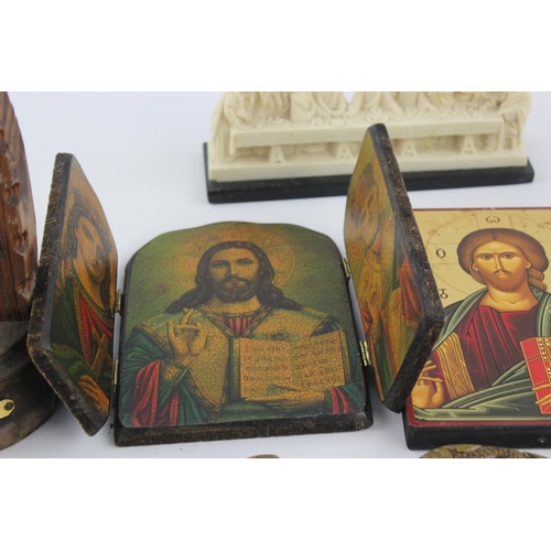 473 - A collection of religious items to include mother of pearl Bible, artwork, crucifix etc.