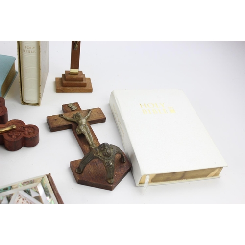 473 - A collection of religious items to include mother of pearl Bible, artwork, crucifix etc.