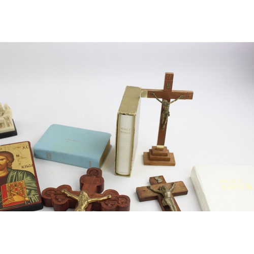 473 - A collection of religious items to include mother of pearl Bible, artwork, crucifix etc.