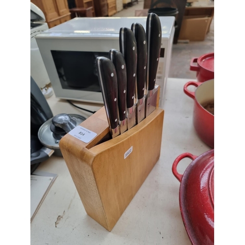 814 - A wooden knife block containing five Richardson Sheffield chef's knives