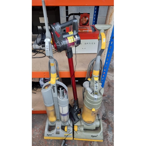 828 - Three bagless vacuum cleaners, one Dyson DC03, one Dyson DC04 and one Beldray cordless with charger