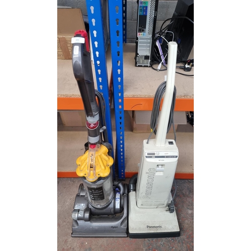 830 - Two upright vacuum cleaners, one Dyson DC33 bagless and one Panasonic MC-E44