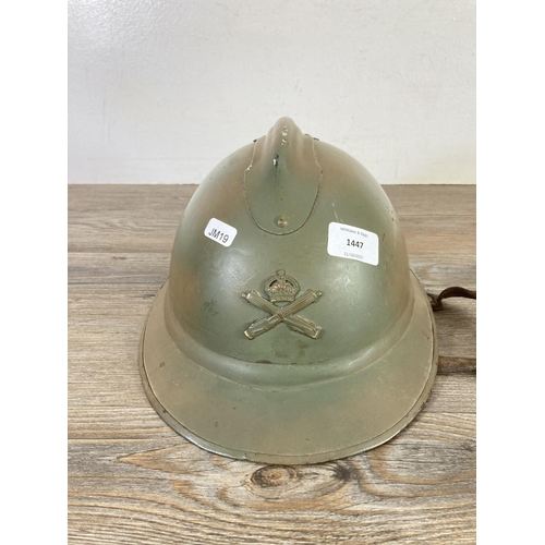 512 - A WWII French Adrian helmet with machine gun corps badge to front