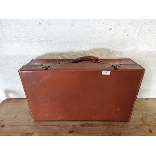 526 - An early 20th century brown leather suitcase - approx. 19cm high x 61cm wide x 35cm deep