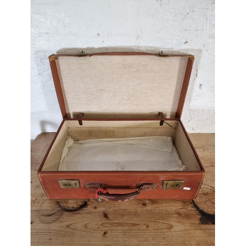 526 - An early 20th century brown leather suitcase - approx. 19cm high x 61cm wide x 35cm deep