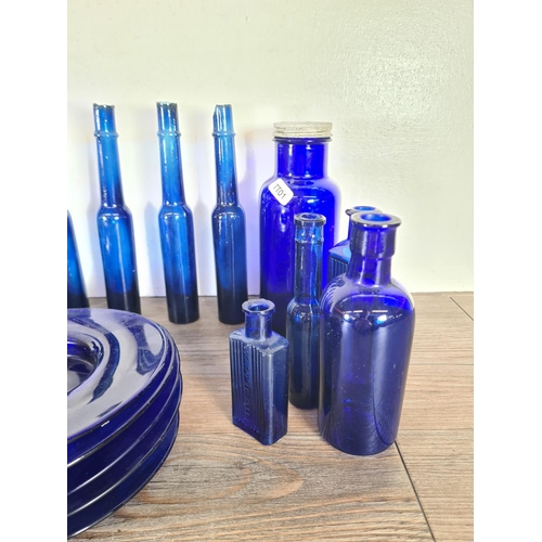 264 - A collection of cobalt blue glassware to include bottles, side plates etc.