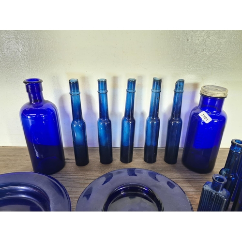 264 - A collection of cobalt blue glassware to include bottles, side plates etc.