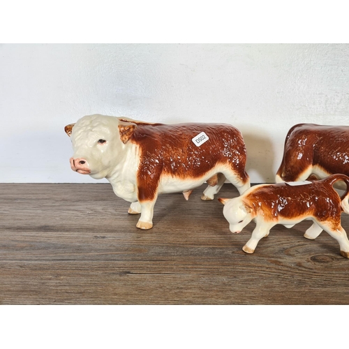 281 - Three ceramic cow figurines