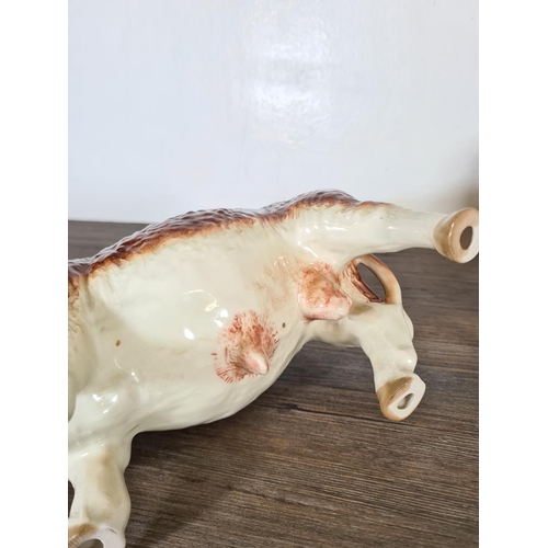 281 - Three ceramic cow figurines