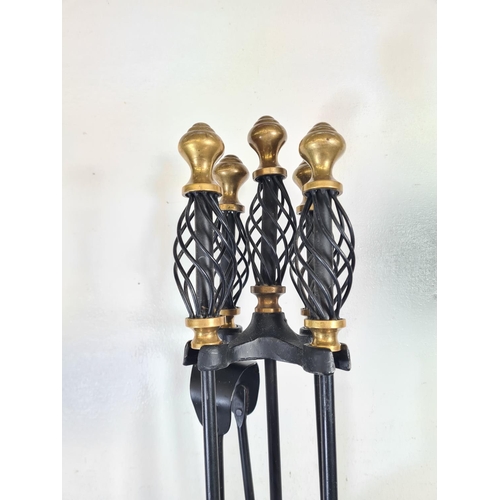 302 - A 19th century style wrought iron and brass companion set - approx. 70cm high