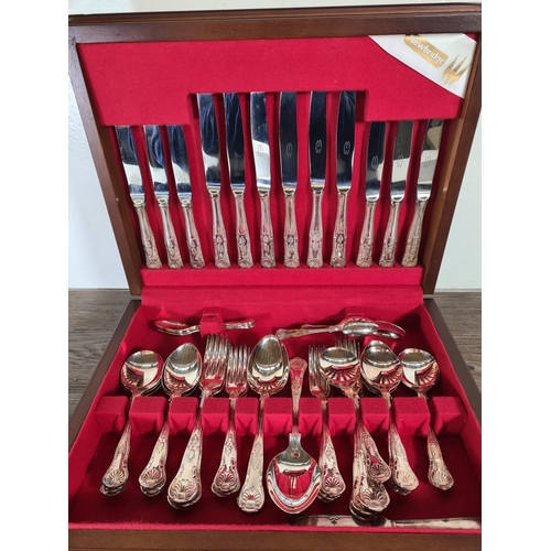 307 - A mahogany canteen containing Newbridge stainless steel King's pattern cutlery, Mayell EP on zinc th... 