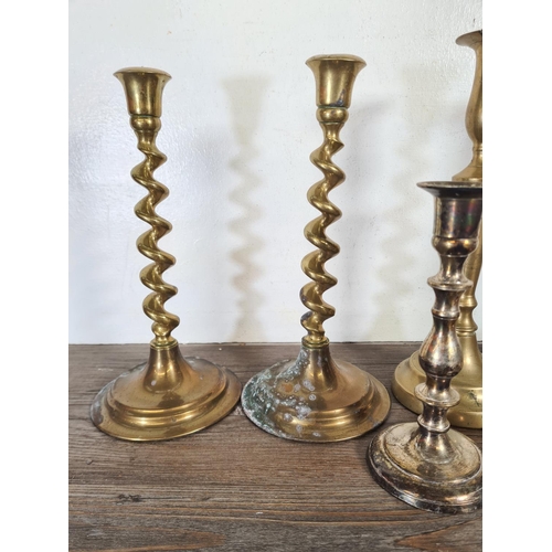 309 - Four pairs of candlesticks to include brass barley twist, silver plated etc.