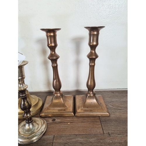 309 - Four pairs of candlesticks to include brass barley twist, silver plated etc.