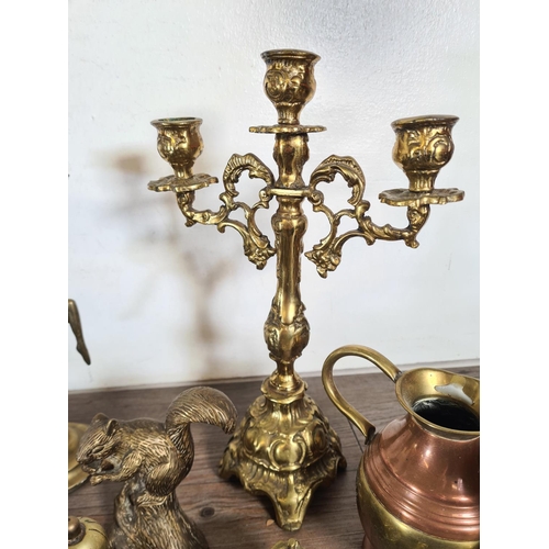 315 - A collection of metalware to include Rococo style brass three branch candelabra, Art Deco style bras... 