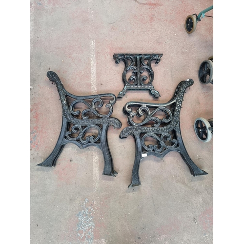 646 - Three matching cast iron items, two pairs of bench ends and pair of table ends