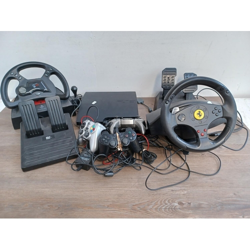 734 - A collection of gaming items to include Mad Catz steering wheel with pedals, Thrustmaster steering w... 