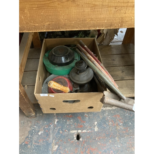 835 - A box containing bow saws, hand scythes, oil lamp, space heaters etc.