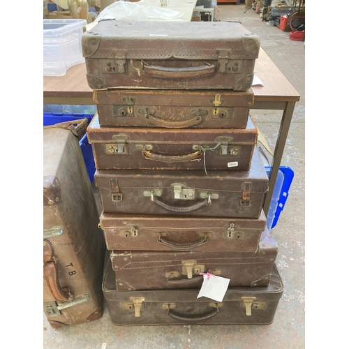 863 - Eight early 20th century leather suitcases