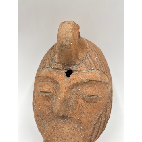 239 - A terracotta head oil lamp - approx. 15cm high x 10cm wide