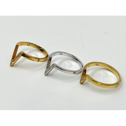 1076 - A boxed Swarovski Delta three piece graduating tri coloured V shaped ring set, size 52