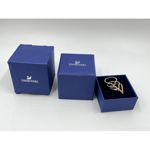 1076 - A boxed Swarovski Delta three piece graduating tri coloured V shaped ring set, size 52