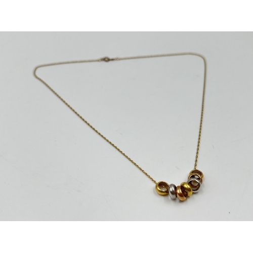 1086 - A hallmarked 14ct gold chain necklace with seven charms - approx. gross weight 2.3 grams