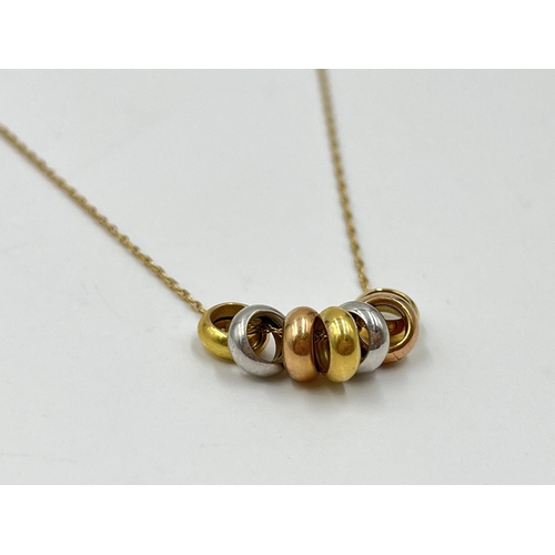 1086 - A hallmarked 14ct gold chain necklace with seven charms - approx. gross weight 2.3 grams