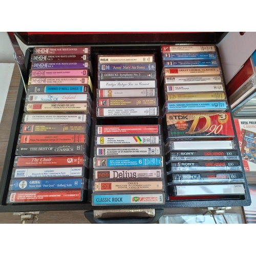 776 - Two boxes and a storage case containing a collection of CDs and compact cassettes - see images for t... 